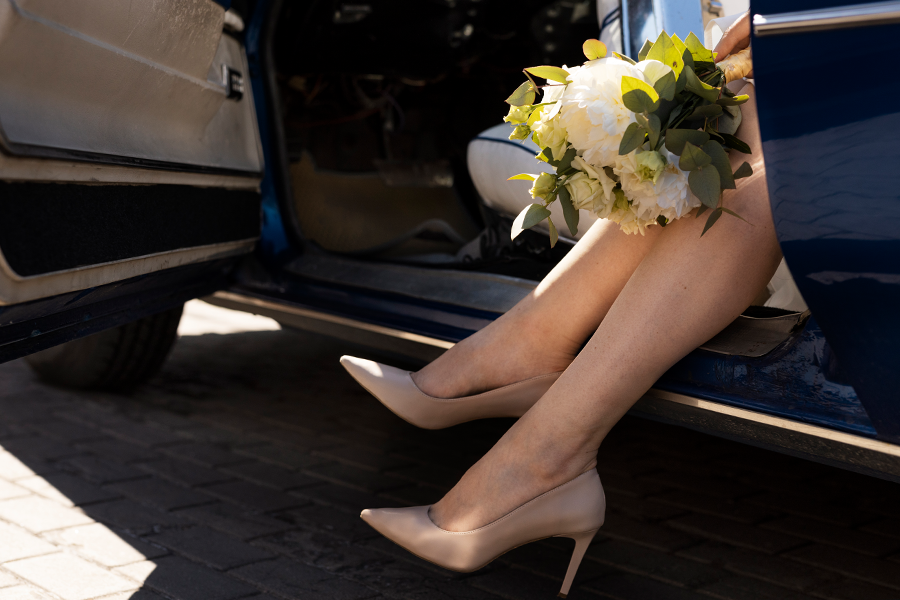 Private taxi for all occasions: a bride stepping out of the car